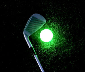 golf club side by side with bright green L.E.D. golf ball