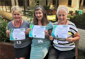 three job coaches holding their Certified Employment Support Professional certificates