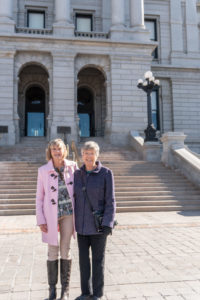 Kathy and friend, Linda, pose for a photo in front of the Colorado Capitol on IDD Awareness Day