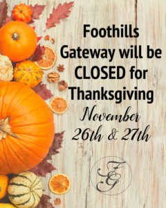 Wooden background with pumpkins and fall leaves and text that says "Foothills Gateway will be CLOSED for Thanksgiving - November 26th and 27th