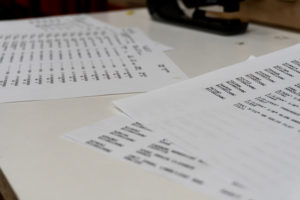 photo of hardware store item sheets, showing how much information Jeff has to scan in order to do his job.